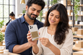 Woman placing actual yantra inside husband’s phone cover at their business